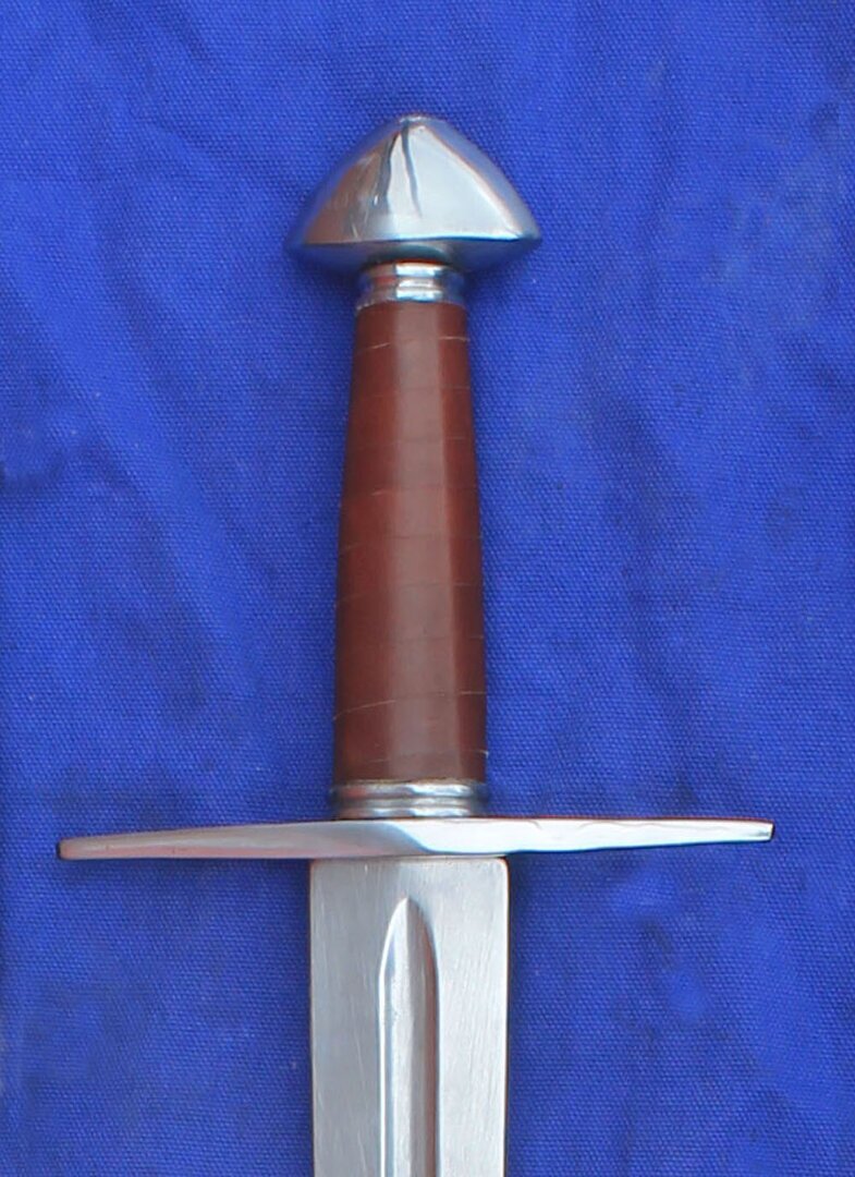 1th/12th Century Norman longsword with fullered blade and Brazil Nut pommel and straight quillon
						Leather grip as standard.
						Various blade dimensions available please confirm when ordering - 
						1.	66cm Blade  5cm Hilt  2.5cm Tip
						2.	76cm Blade  5cm Hilt  2.5cm Tip
						3.	76cm Blade  5cm Hilt  1.9cm Tip
						4.	76cm Blade  3.8cm Hilt  2.5cm Tip
						5.	76cm Blade  3.8cm Hilt 1.9cm Tip
						