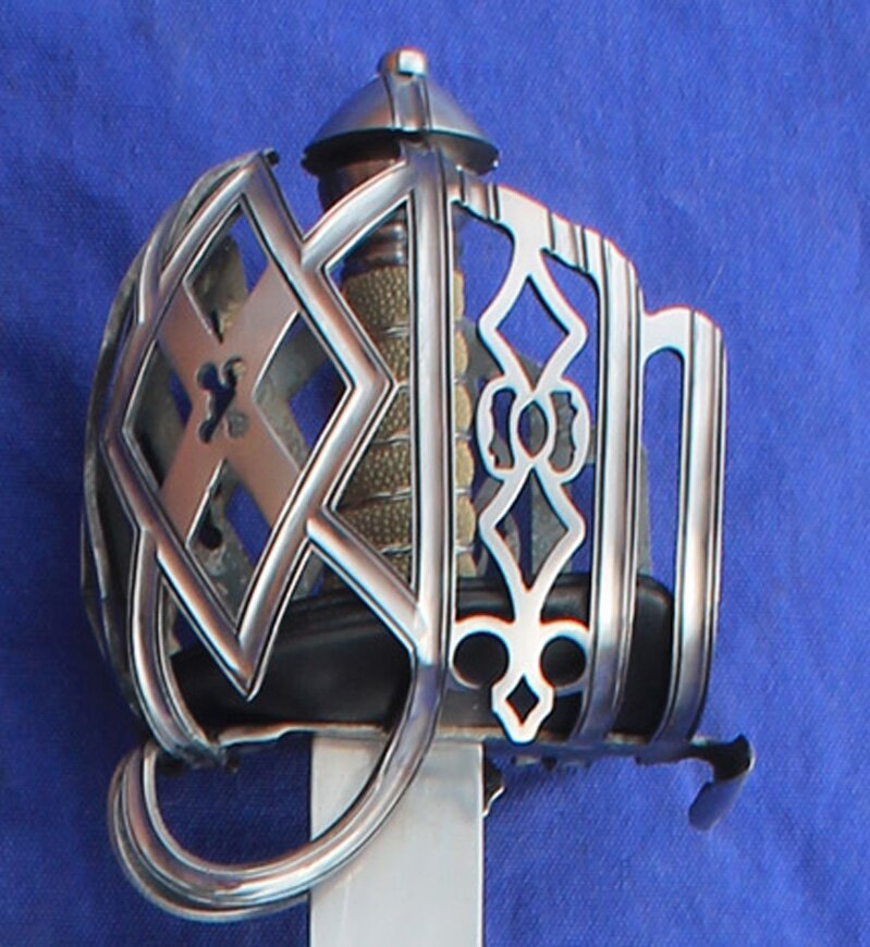 Diamond Style Basket Hilt. Has fullered bar work and panels bordered with incised lines, Satin finish. With Shark Skin grip and silver wire 
						and leather pad liner 
						Please state required options in message section of cart when ordering 
						Hilt finish  (Polished, Satin, Blued or Browned)
						Blade Dimensions
						Sharp
						84cm Blade  3.8cm Hilt  1.9cm Tip
						Reenactment
						76cm Blade  3.8cm Hilt  1.9cm Tip
						Back Edge
						84cm Blade  3.2cm Hilt  1.9cm Tip
