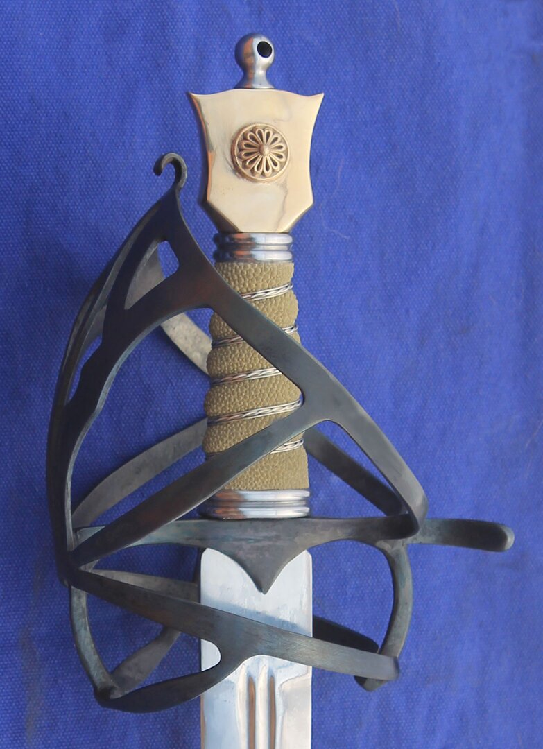 Fairly simple early Schiavona guard with a blued hilt, rayskin and wire grip and bronze Cats head Pommel.