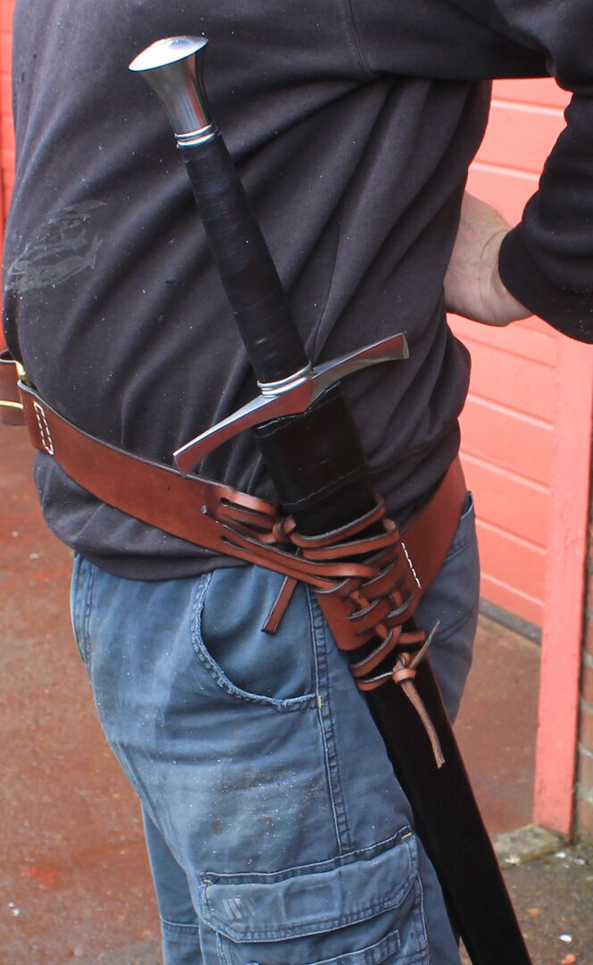 Leather waist belt with split belt lacing to angle scabbard. Sword shown worn angled at the hip.