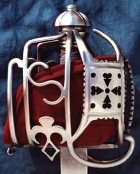 Polished hilt, panels decorated with triangle and circular punched holes, S bars at the rear a red linen covered leather liner.